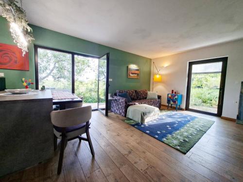 a living room with a couch and a table at Casa Rosa Istria in Kućibreg