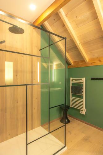 a glass staircase in a room with a wooden ceiling at Les Chalets de l'Ours in Cauterets
