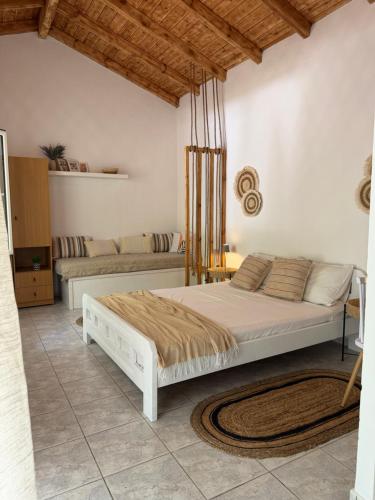 a bedroom with two beds and a couch at The Beach House in Vasilika