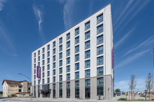 a tall white building on a city street at Premier Inn Bremerhaven in Bremerhaven