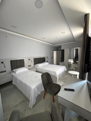 a hotel room with two beds and a desk at Sesse suit in Istanbul