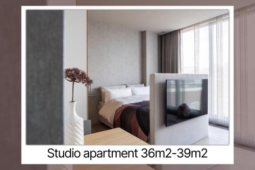 a television in a room with a bed at 348 Suites Short Stay in The Hague