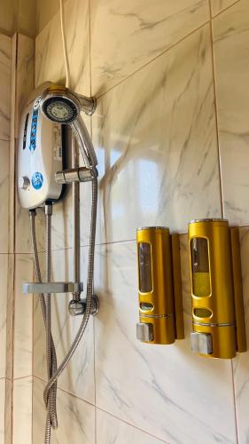 a shower head and lights on a wall at Chateau La Princesa with cozy garden & bar in Puerto Princesa City
