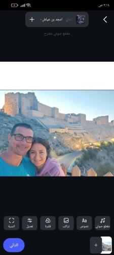 a picture of a man and a woman on a television screen at Bubble Castel Boutique Hotel in Kerak