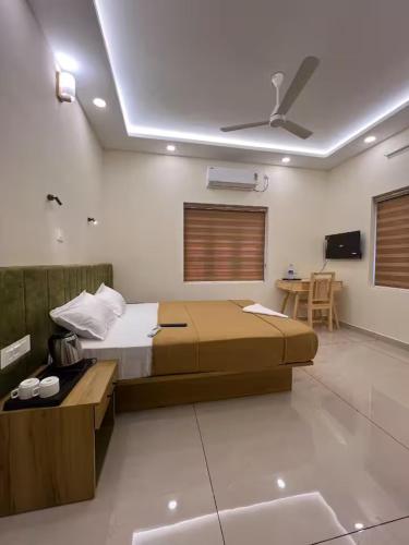 a bedroom with a bed and a table in it at Ayra Inn in Cochin