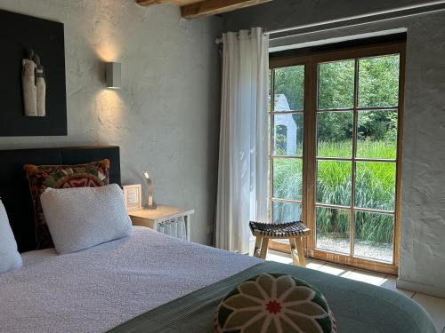 a bedroom with a bed and a large window at Stee 23 in Hertsberge