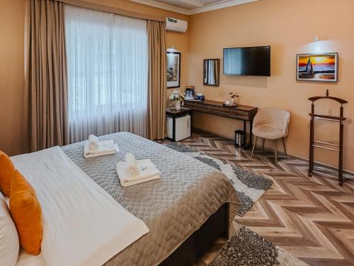 a hotel room with a bed and a desk at Guest house TWINS in Tashkent
