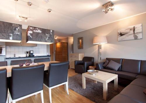 a living room with a couch and a table at Appart Laijola in Gaschurn