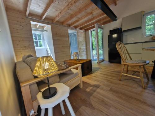 a living room with a couch and a table at oud in Zonnebeke