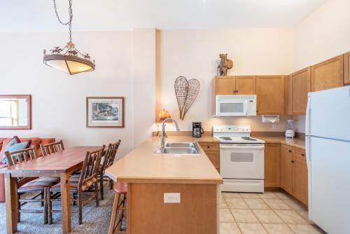 a kitchen and dining room with a table and a refrigerator at Copper Springs Lodge 426 in Copper Mountain