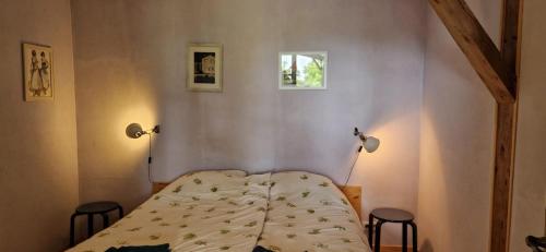 a bedroom with a bed and two stools in it at Gauguin in Douzains