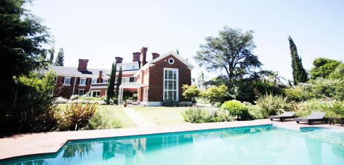 a house with a swimming pool in front of a house at Le Bibló in Montevideo