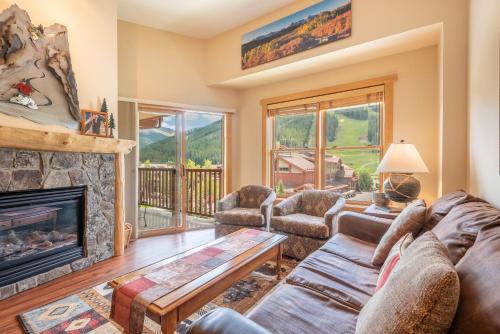 a living room with a couch and a fireplace at Copper Springs Lodge 433 in Copper Mountain