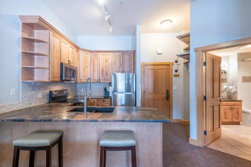 a kitchen with a sink and a refrigerator at Copper Springs Lodge 404 in Copper Mountain