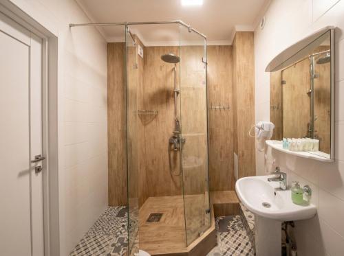 a bathroom with a shower and a sink at Oasis Hostel in Kostanay