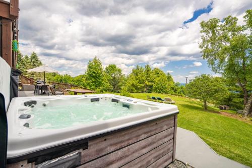 a jacuzzi tub on the side of a house at Appalachian Mountain Lodge in Boone