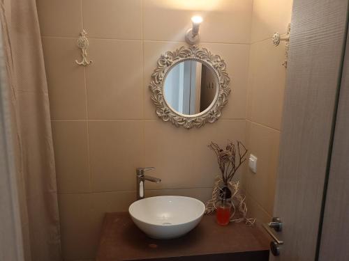 a bathroom with a sink and a mirror at The Eliana Serenade in Heraklio