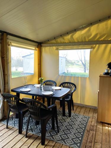 a dining room with a table and chairs at TIthome in Cunlhat