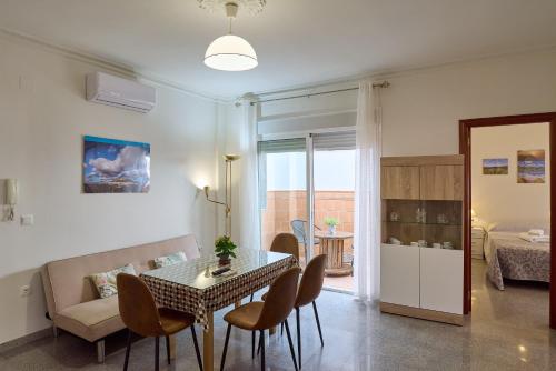 a living room with a table and chairs and a couch at Apartamento La Molina in Rute