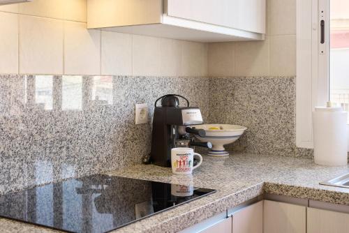 a kitchen with a coffee maker on a counter at Apartamento La Molina in Rute