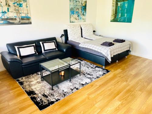 a living room with a couch and a bed at Relax Holidays in Rheinheim