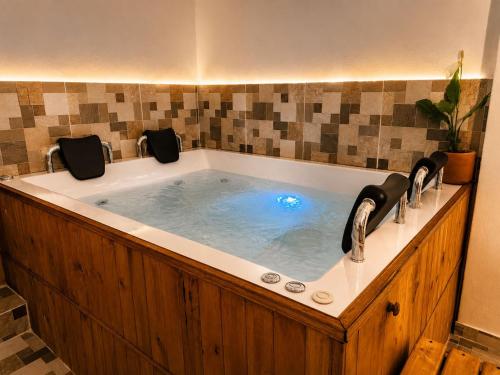 a large bath tub with two faucets in a bathroom at hotel spa 360 villa de leyva in Villa de Leyva