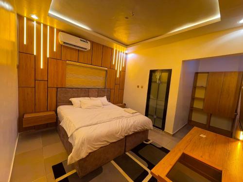 a bedroom with a large bed in a room at MOTISOFT Hotel in Yenagoa