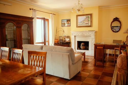 a living room with a couch and a fireplace at Bed & Breakfast Spigolatrice in Sapri
