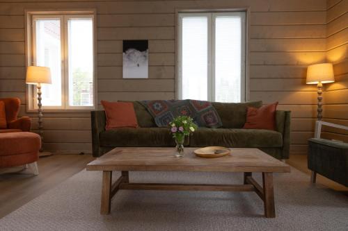 a living room with a couch and a coffee table at Villa Aattu in Muonio