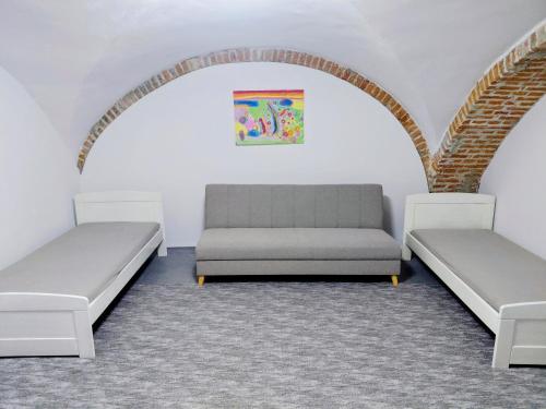 two beds in a room with an arch at Ubytovanie Čadca in Čadca