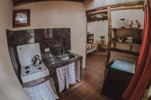 a kitchen with a stove and a sink at Hostal Rosa Mística in Montañita