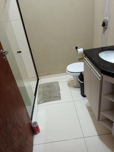a bathroom with a toilet and a sink at Pedacinho do céu 3 in Dourados
