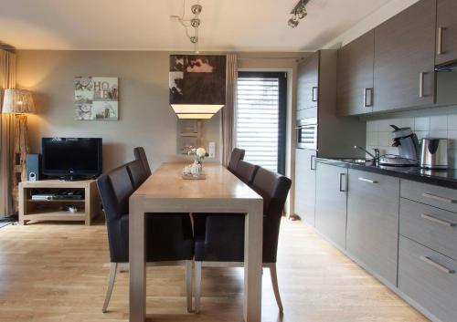 a kitchen with a dining room table and chairs at Appart Laijola in Gaschurn