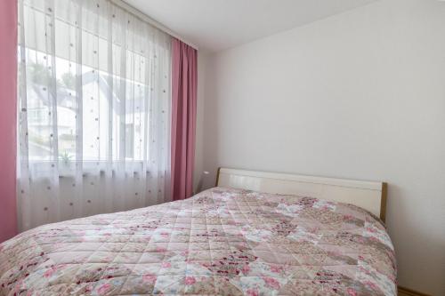 a bedroom with a bed and a window at Traumwohnung am Sorpesee in Sundern