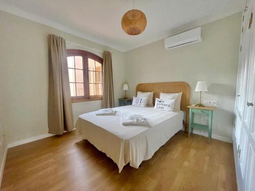 a bedroom with a large white bed and a window at La Casa de Papel 2 in Valle Gran Rey