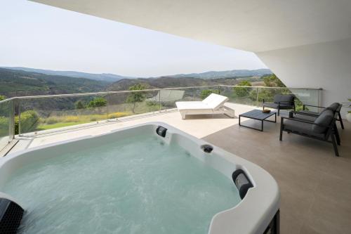 a hot tub on the balcony of a house at Agua Hotels Mondim de Basto in Mondim de Basto