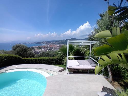 a villa with a pool and a view of the ocean at Vista Resort OPENING 13-7-26 in Albisola Superiore