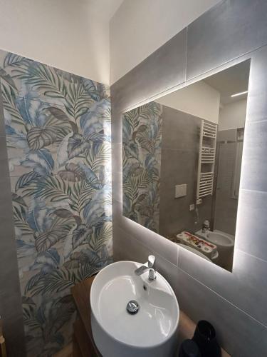 a bathroom with a sink and a mirror at Anima Est in Naples