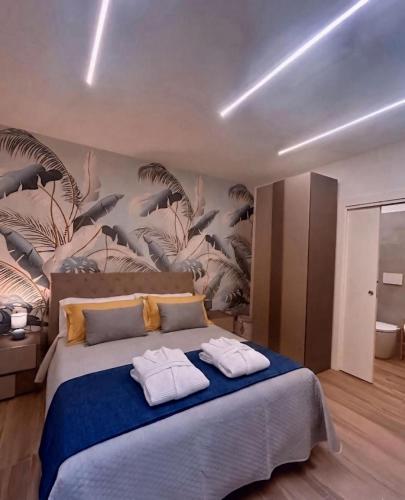 a bedroom with a large bed with towels on it at Anima Est in Naples