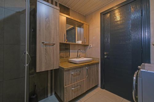 a bathroom with a sink and a shower at Villa ay yıldız in Belek