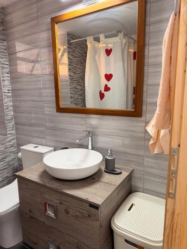 a bathroom with a sink and a mirror at The Stone Loft in Arfará