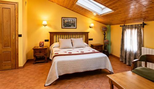 a bedroom with a large bed in a room at Hostal Don Juan in Alarcón