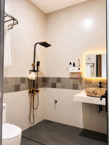 a bathroom with a shower and a toilet and a sink at Homestay ĐAN MY 2 in Trung Nghĩa