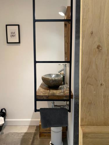 a bathroom with a sink and a mirror at Stee 23 in Hertsberge