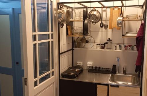 a small kitchen with a sink and a window at Villa ÕU apartments in Pärnu