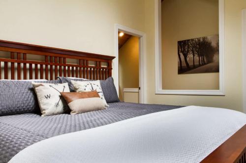 a bedroom with a bed with pillows on it at Rivers Edge at Snowater in Glacier