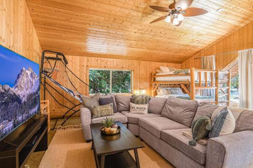 a living room with a couch and a flat screen tv at Stargazer Chalet in Glacier