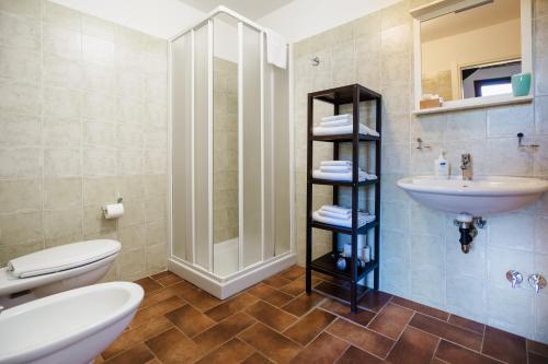 a bathroom with a sink and a toilet and a shower at Agriturismo Ristorante Monte Argentario in Monte Argentario