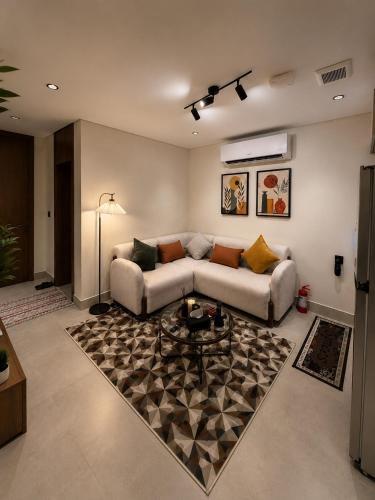 a living room with a couch and a rug at سويت إبرام- بتصميم فاخر بدخول ذاتي in Dammam