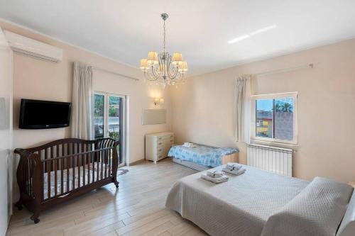 a bedroom with a bed and a crib in it at DIEGOPAS Sweet Home in SantʼAntonio Abate